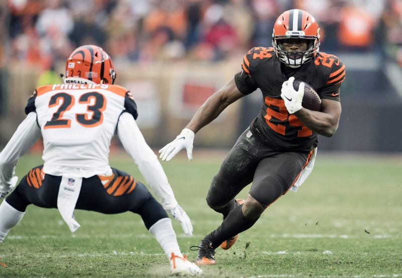 Dec 23, 2018; Cleveland, OH, USA; Cleveland Browns running back Nick Chubb (24) runs with the ball as Cincinnati Bengals cornerback Darius Phillips (23) defends during the second half at FirstEnergy Stadium. Mandatory Credit: Ken Blaze-USA TODAY Sports