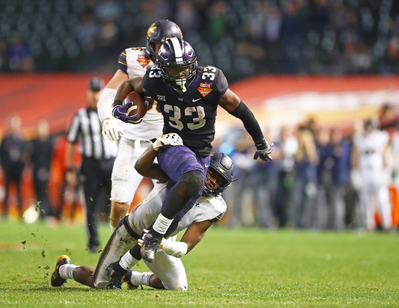 Dec 26, 2018; Phoenix, AZ, USA; Texas Christian Horned Frogs running back Sewo Olonilua (33) is tackled by California Golden Bears safety Jaylinn Hawkins (6) in the 2018 Cheez-It Bowl at Chase Field. 