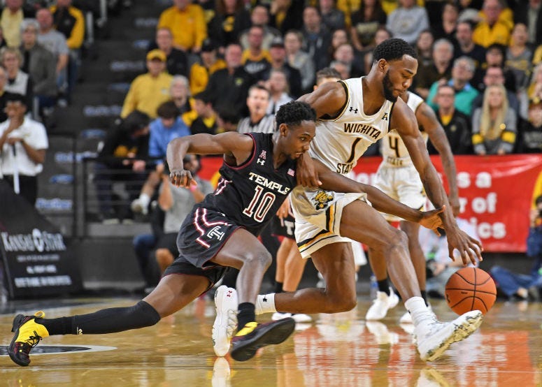 Jan 6, 2019; Wichita, KS, USA; Temple Owls guard Shizz Alston Jr. (10) reaches in for the ball against Wichita State Shockers forward Markis McDuffie (1) during the second half at Charles Koch Arena. 