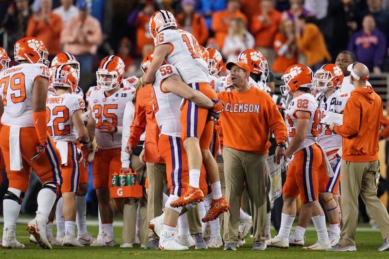 Clemson quarterback Trevor Lawrence (16) is greeted defensive tackle Jordan Williams (59) and head coach Dabo Swinney during the fourth quarter in the 2019 College Football Playoff cChampionship game against Alabama on Jan. 6, 2018, in Santa Clara, Calif.