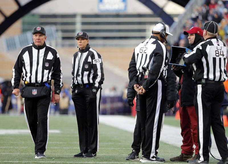 NFL referees wait for a replay during game