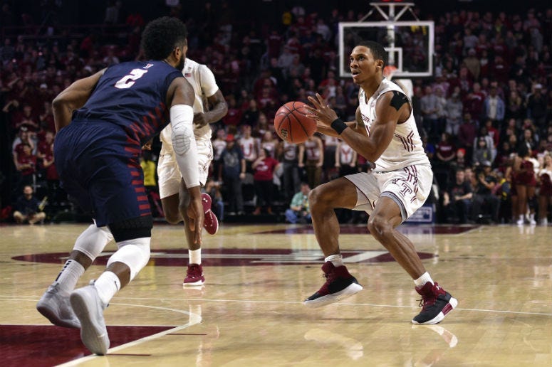 Jan 19, 2019; Philadelphia, PA, USA; Temple Owls guard Nate Pierre-Louis (15) takes a shot past Pennsylvania Quakers guard Antonio Woods (2) during the second half at Liacouras Center.