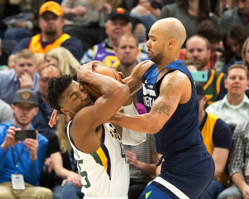 Wolves guard Jerryd Bayless tries to take the ball from Donovan Mitchell