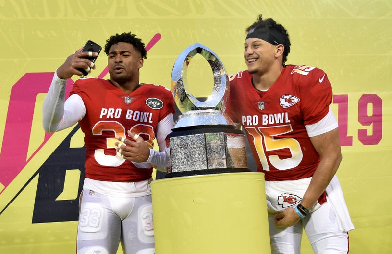 AFC strong safety Jamal Adams of the New York Jets (left) poses with the trophy next to AFC quarterback Patrick Mahomes of the Kansas City Chiefs