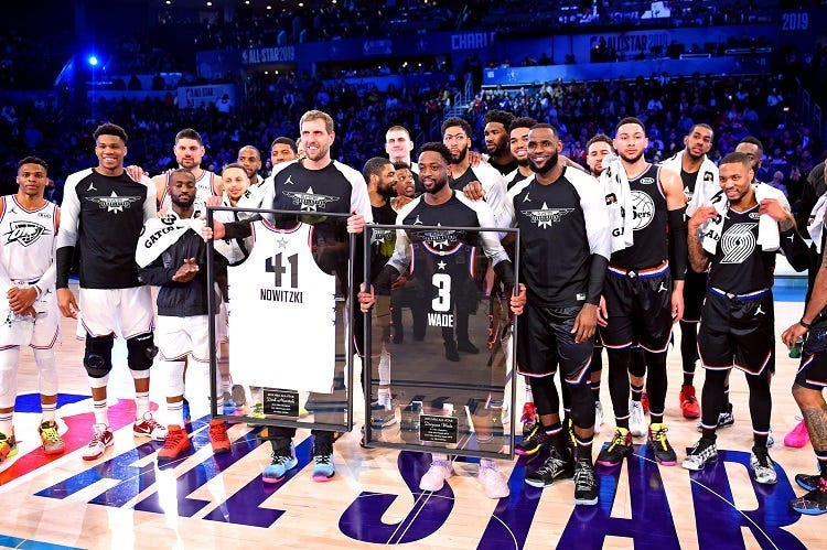 Team Lebron guard Dwayne Wade of the Miami Heat (3) and Team Giannis forward Dirk Nowitzki of the Dallas Mavericks (41) are honored during the 2019 NBA All-Star Game at Spectrum Center.