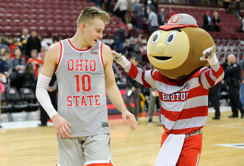 Feb 26, 2019; Columbus, OH, USA; Ohio State Buckeyes forward Justin Ahrens (10) celebrates with mascot Brutus Buckeye after leading the team in scoring against the Iowa Hawkeyes at Value City Arena. Mandatory Credit: Joe Maiorana-USA TODAY Sports