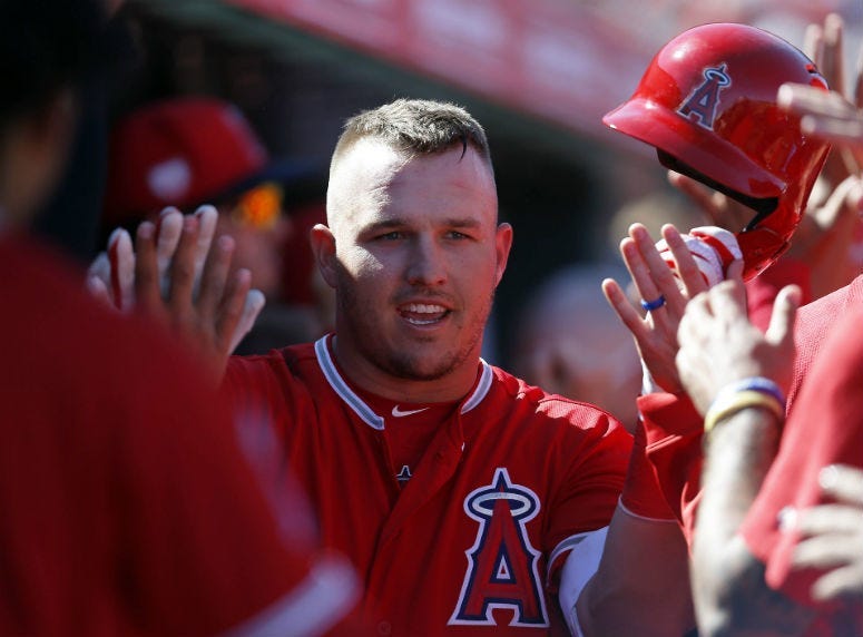 Los Angeles Angels center fielder Mike Trout (27) celebrates after hitting a two run home run in the third inning during a spring training game against the Chicago Cubs at Tempe Diablo Stadium.