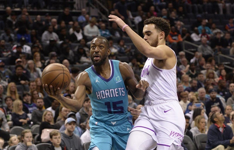 Timberwolves guard Tyus Jones and Charlotte guard Kemba Walker