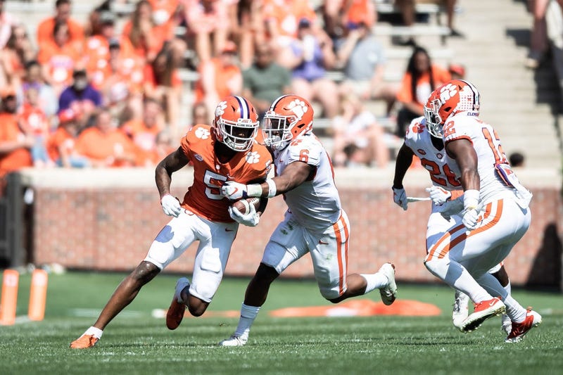 Clemson wide receiver Tee Higgins (5) attempts to break through a tackle by Clemson linebacker Mike Jones Jr. (6) during the Spring Game at Memorial Stadium Saturday, April 6, 2019. 