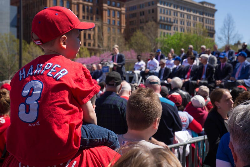 Apr 16, 2019; Philadelphia, PA, USA; A young fan looks on as Philadelphia Phillies owner John Middleton addresses fans and media during an event at Independence Mall to announce Philadelphia as the host of the 2026 All Star Game.