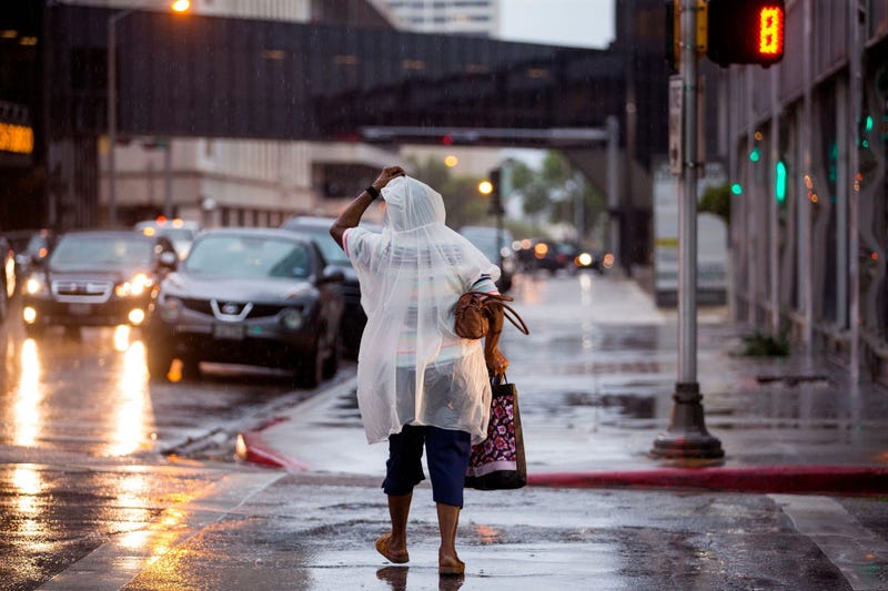 A woman walks in the rain