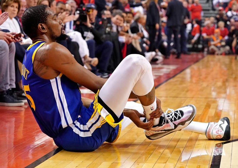 Golden State Warriors forward Kevin Durant (35) sits on the court after an apparent injury during the second quarter in game five against the Toronto Raptors of the 2019 NBA Finals at Scotiabank Arena.
