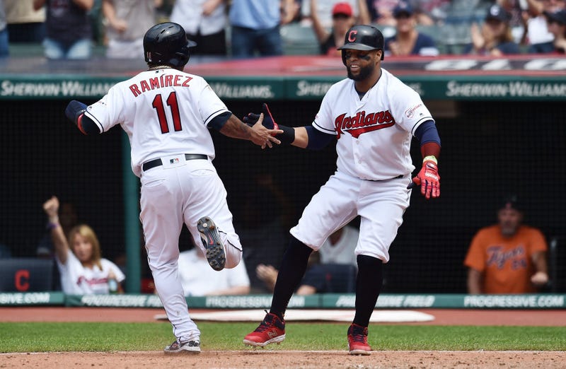 Cleveland Indians third baseman Jose Ramirez (11) and designated hitter Carlos Santana (41) celebrate after scoring during the eighth inning at Progressive Field.