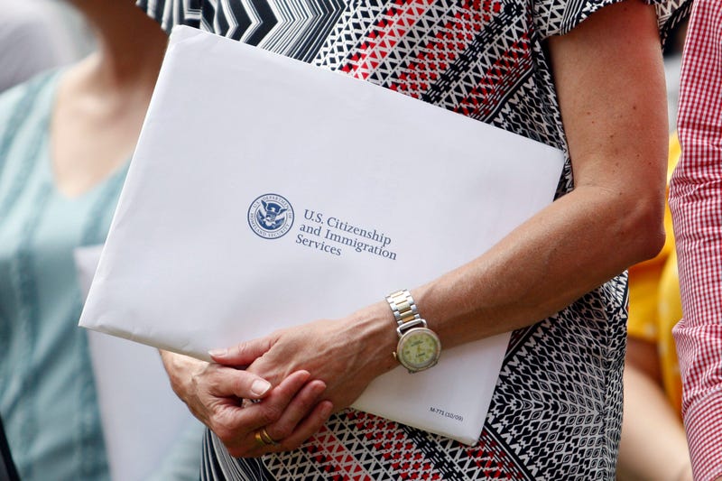Jun 27, 2019; Detroit, MI, USA; A woman holds her citizenship paperwork before the game between the Detroit Tigers and the Texas Rangers at Comerica Park.