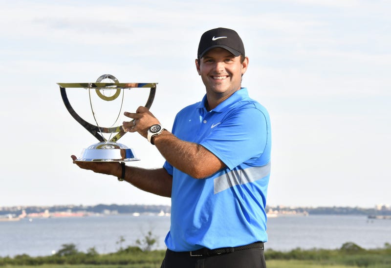 Patrick Reed poses with the winners trophy after winning The Northern Trust
