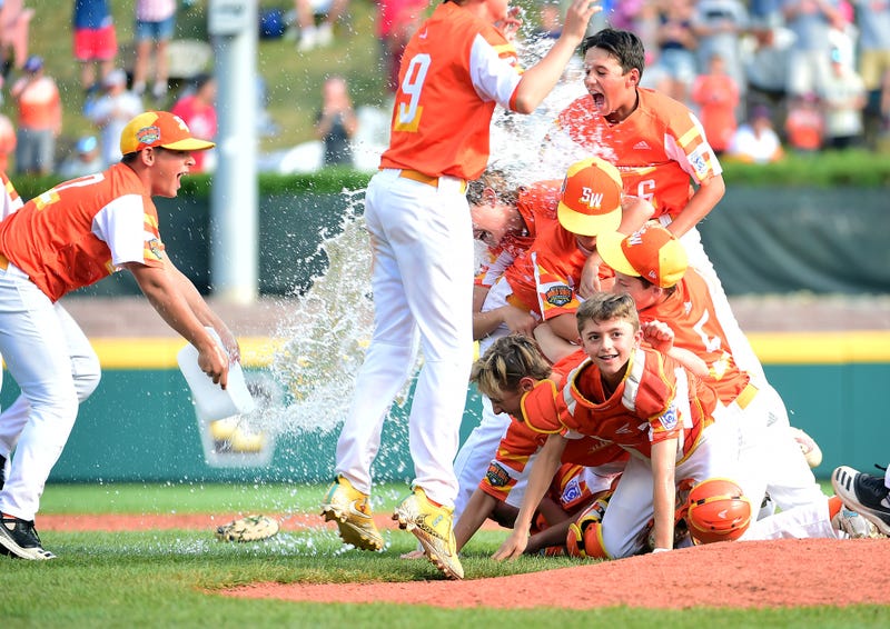 Southwest Region players celebrate after beating the Caribbean Region 8-0 during the Little League World Series at Howard J. Lamade Stadium.