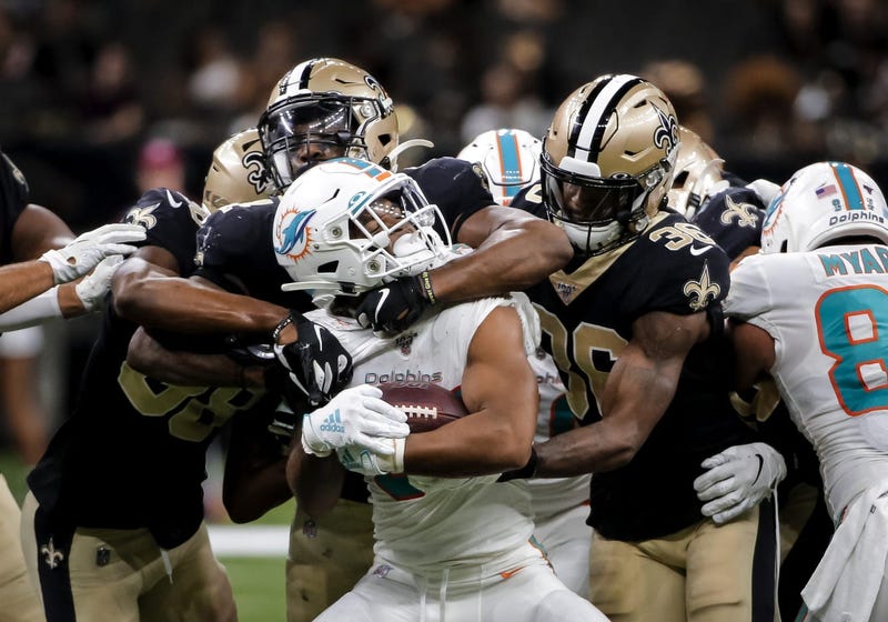 Aug 29, 2019; New Orleans, LA, USA; New Orleans Saints linebacker Darnell Sankey (44) and defensive back T.J. Green (36) tackle Miami Dolphins running back Myles Gaskin (37) during the second half of a preseason game at the Mercedes-Benz Superdome.