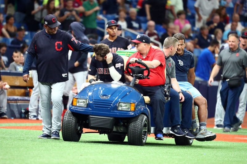  Cleveland Indians right fielder Tyler Naquin (30) is greeted by manager Terry Francona (77) while being carted off the field after an apparent injury at the end of the fifth inning against the Tampa Bay Rays at Tropicana Field.