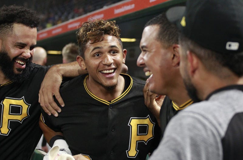 ittsburgh Pirates left fielder Erik Gonzalez (middle) laughs with Pittsburgh relief pitcher Richard Rodriguez (left) and third baseman Jose Osuna (right center) and outfielder Melky Cabrera (right) in the dugout against the Chicago Cubs