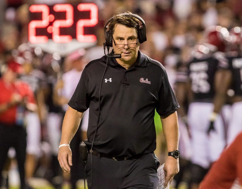 South Carolina Gamecocks head coach Will Muschamp checks on an injured player against the Kentucky Wildcats at Williams-Brice Stadium.