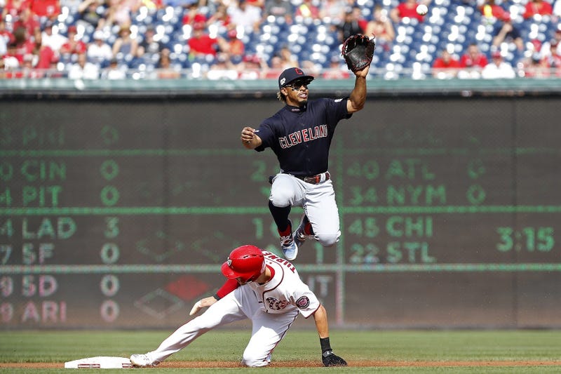 Sep 29, 2019; Washington, DC, USA; Washington Nationals shortstop Trea Turner (7) steals second base as Cleveland Indians shortstop Francisco Lindor (12) leaps to catch the throw from home plate in the first inning at Nationals Park. Mandatory Credit: Geo