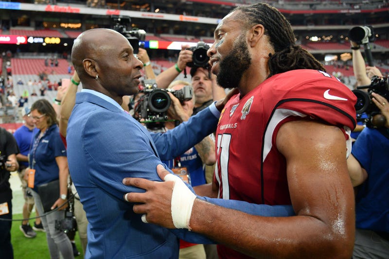Jerry Rice and Larry Fitzgerald catch up after a game