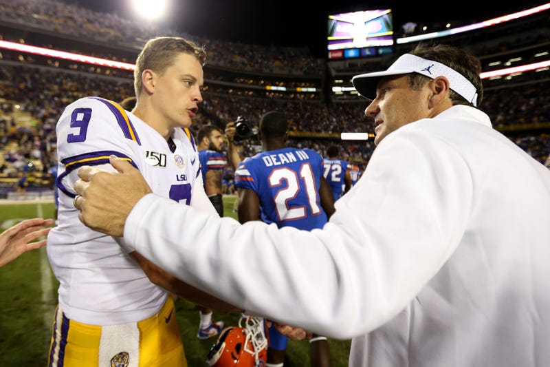 LSU Tigers quarterback Joe Burrow (9) shakes hands with Florida Gators head coach Dan Mullen at the end of their game at Tiger Stadium.