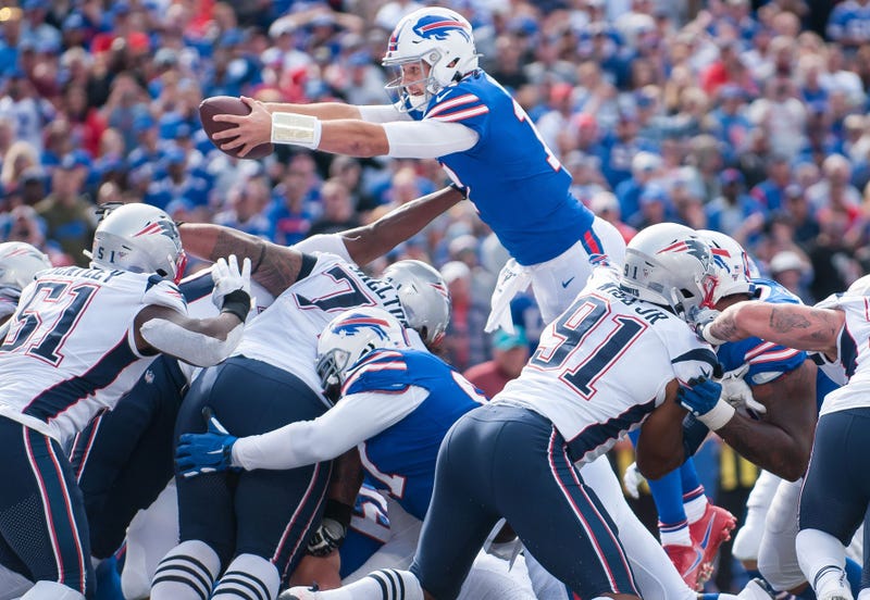 Buffalo Bills quarterback Josh Allen (17) reaches the ball across the goal line to score a touchdown against the New England Patriots in the third quarter at New Era Field. Mark Konezny-USA TODAY Sports