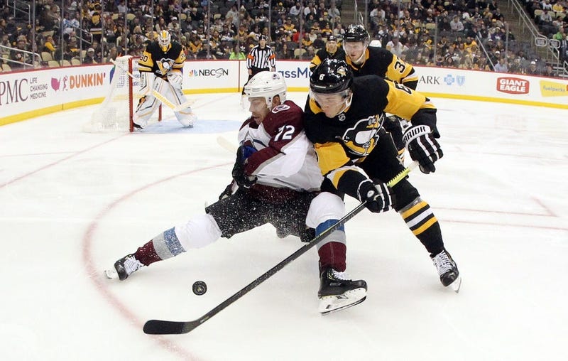 Colorado Avalanche right wing Joonas Donskoi is checked off of the puck by Pittsburgh Penguins defenseman John Marino