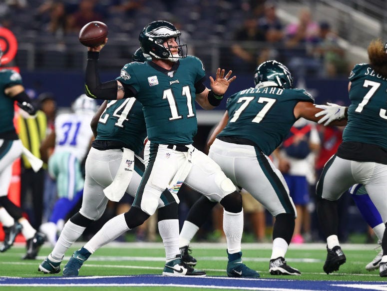 Philadelphia Eagles quarterback Carson Wentz (11) throws in the pocket in the third quarter against the Dallas Cowboys at AT&T Stadium.