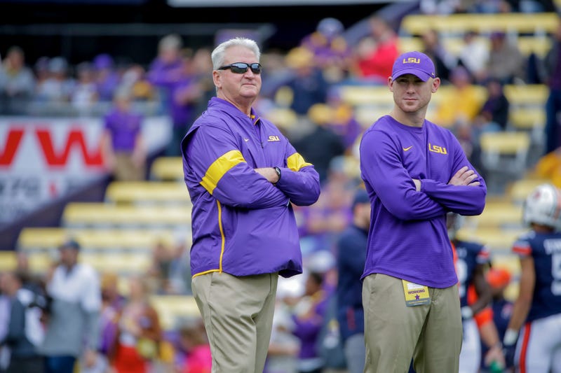 LSU Tigers offensive coordinator Steve Ensminger and passing game coordinator Joe Brady (right) watch during warm ups prior to kickoff against the Auburn Tigers at Tiger Stadium.