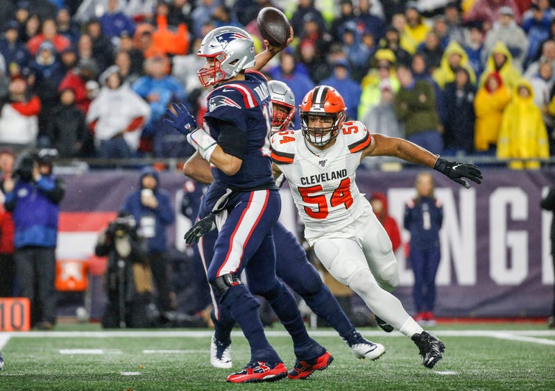 Oct 27, 2019; Foxborough, MA, USA; New England Patriots quarterback Tom Brady (12) makes a pass while pressured by Cleveland Browns defensive end Olivier Vernon (54) during the second half at Gillette Stadium. Mandatory Credit: Greg M. Cooper-USA TODAY Sp