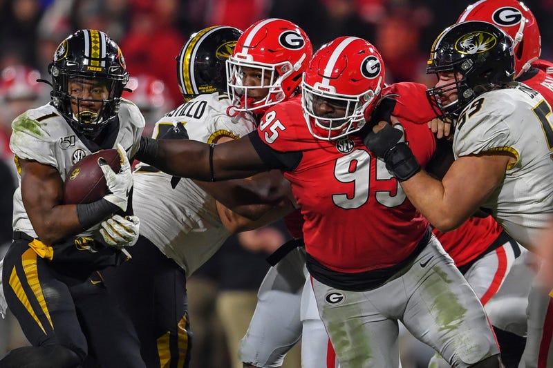 Nov 9, 2019; Athens, GA, USA; Missouri Tigers running back Tyler Badie (1) is tackled by Georgia Bulldogs defensive lineman Devonte Wyatt (95) during the second half at Sanford Stadium. Mandatory Credit: Dale Zanine-USA TODAY Sports