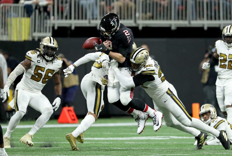 Atlanta Falcons quarterback Matt Ryan (2) fumbles the ball as he is hit by New Orleans Saints cornerback Marshon Lattimore (23) and defensive end Marcus Davenport (92) in the second half at Mercedes-Benz Stadium.