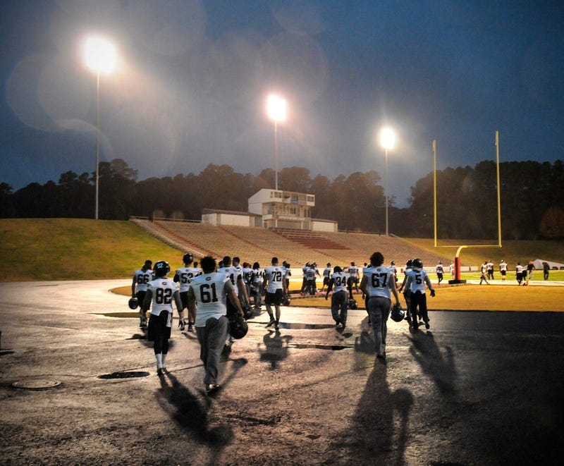 St. Cloud State players take the field in a light rain to practice Friday, Nov. 22, 2013, 