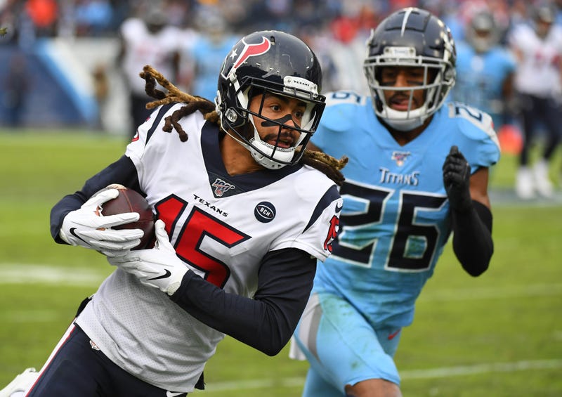 Houston Texans wide receiver Will Fuller (15) catches a pass past coverage fro Tennessee Titans cornerback Logan Ryan (26) during the second half at Nissan Stadium.