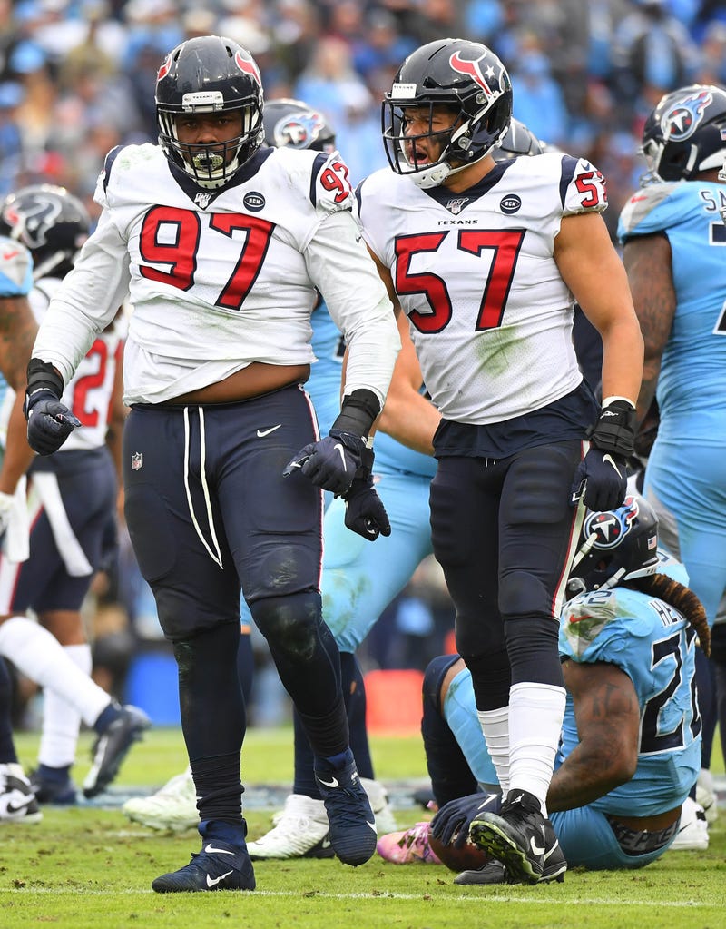 Houston Texans defensive end Angelo Blackson (97) and Houston Texans outside linebacker Brennan Scarlett (57) after a stop on a run from Tennessee Titans running back Derrick Henry (22) during the second half at Nissan Stadium.