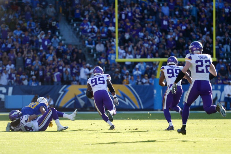 Dec 15, 2019; Carson, CA, USA; Minnesota Vikings defensive end Ifeadi Odenigbo (95) scoops up a fumble and runs it back for a touchdown against the Los Angeles Chargers during the second quarter at Dignity Health Sports Park.