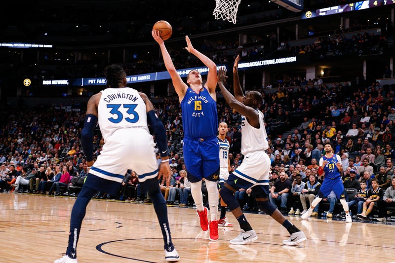 Denver Nuggets center Nikola Jokic (15) shoots the ball as Minnesota Timberwolves center Gorgui Dieng (5) defends in the first quarter at the Pepsi Center.