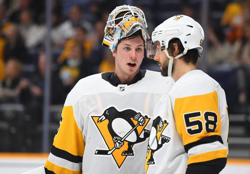 ittsburgh Penguins goaltender Tristan Jarry (35) talks with Pittsburgh Penguins defenseman Kris Letang 