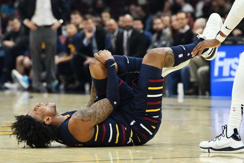 Jan 5, 2020; Cleveland, Ohio, USA; Cleveland Cavaliers guard Kevin Porter Jr. (4) holds his knee after suffering an injury during the second half against the Minnesota Timberwolves at Rocket Mortgage FieldHouse. Mandatory Credit: Ken Blaze-USA TODAY Sport