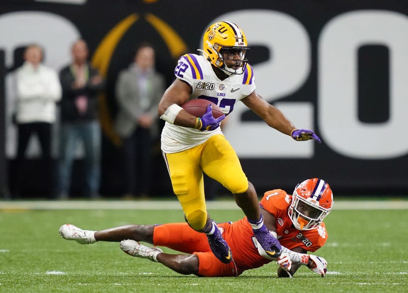 LSU Tigers running back Clyde Edwards-Helaire (22) runs past Clemson Tigers cornerback Derion Kendrick (1) in the fourth quarter in the College Football Playoff national championship game at Mercedes-Benz Superdome.