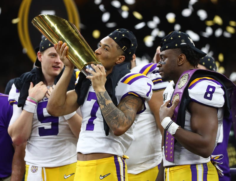 LSU Tigers safety Grant Delpit (7) kisses the national championship trophy after defeating the Clemson Tigers in the College Football Playoff national championship game at Mercedes-Benz Superdome.