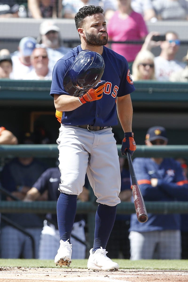  Houston Astros second baseman Jose Altuve (27) recovers his helmet after it fell off on a swing during the first inning against the Detroit Tigers at Publix Field at Joker Marchant Stadium.