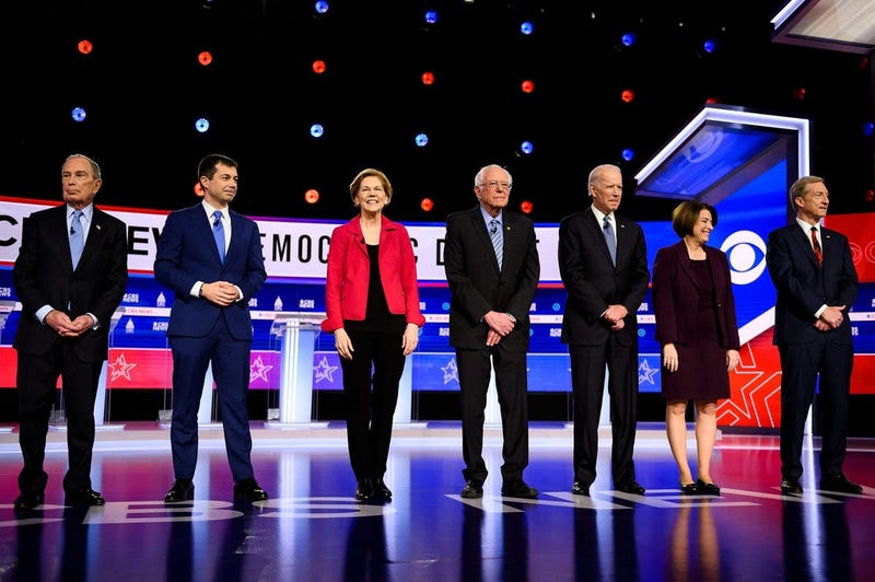 Democratic presidential candidates Michael Bloomberg, Pete Buttigieg, Elizabeth Warren, Bernie Sanders, Joe Biden, Amy Klobuchar and Tom Steyer walk onto the stage during the South Carolina Democratic debate in Charleston Tuesday, Feb. 25, 2020.