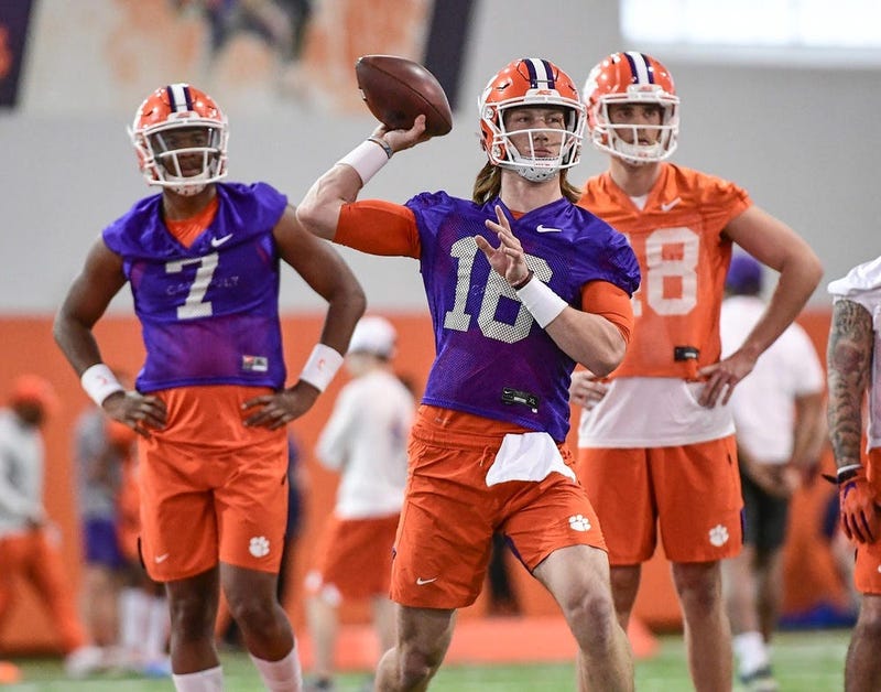 Clemson quarterback Trevor Lawrence(16) passes near quarterback Taisun Phommachanh(7) and punter Will Spiers(48) during Spring practice at the Poe Indoor Facility in Clemson Friday, February 28, 2020. 