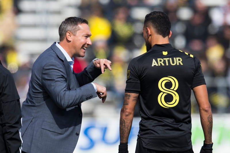 Columbus Crew SC head coach Caleb Porter talks with midfielder Artur (8) as an injured New York City FC player is treated in the first half at MAPFRE Stadium. 