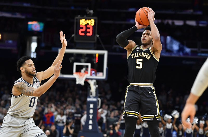 Villanova Wildcats guard Justin Moore (5) shoots as Georgetown Hoyas guard Jahvon Blair (0) looks on during the first half at Capital One Arena.