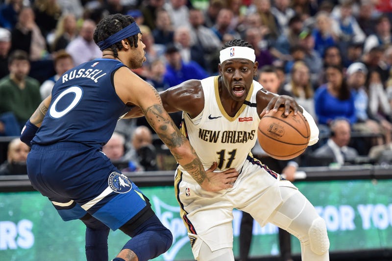 New Orleans Pelicans guard Jrue Holiday (11) controls the ball as Minnesota Timberwolves guard D'Angelo Russell (0) defends during the second quarter at Target Center.
