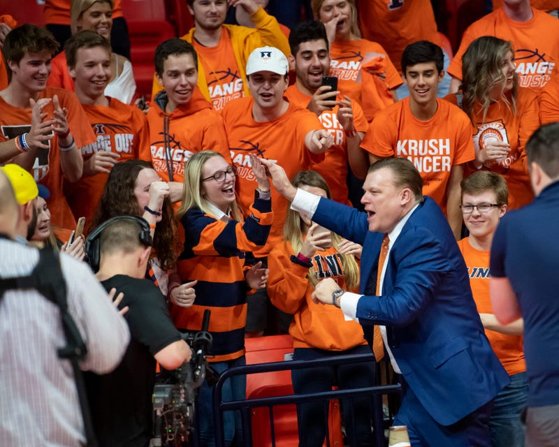 Illinois coach Brad Underwood celebrates with fans.